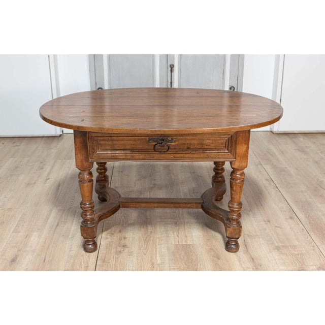 This elegant 20th-century French center table is a beautifully crafted piece that blends functionality with classic French...