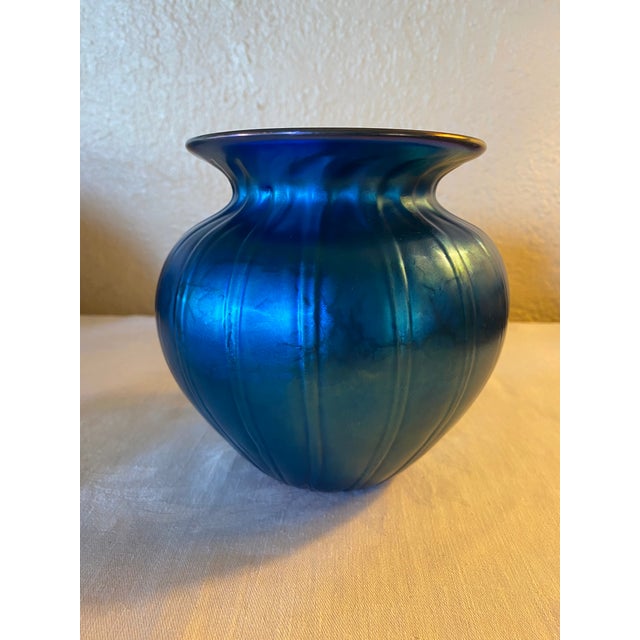Gorgeous iridescent hand blown blue ribbed art glass vase with iridescent gold rim, marked "LS '95" to indicate Lundberg...