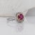 This 14K gold vintage inspired ring features a round ruby framed by a cushion double halo with a pave diamond studded...