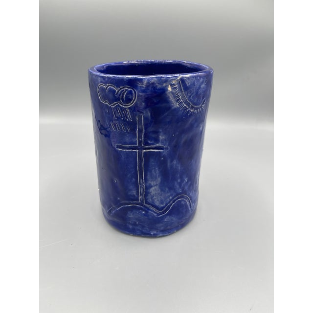 This striking studio art pottery vessel features a rich cobalt blue glaze with a hand-incised open-book design across the...