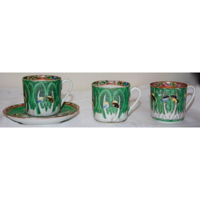 This set of porcelain consists of a dessert plate, saucer and three demitasse cups. They are hand painted with cabbage...