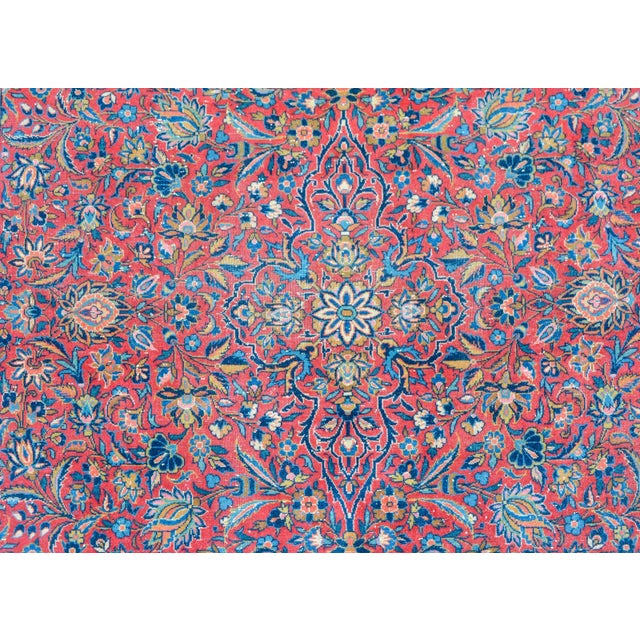 A fantastic early 20th century Persian Kashan rug with an all-over mirrored floral and leaf pattern woven in myriad colors...