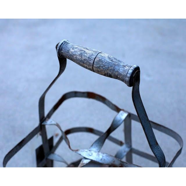 Antique bottle carrier with wooden handle. Holds 4 bottles of wine.