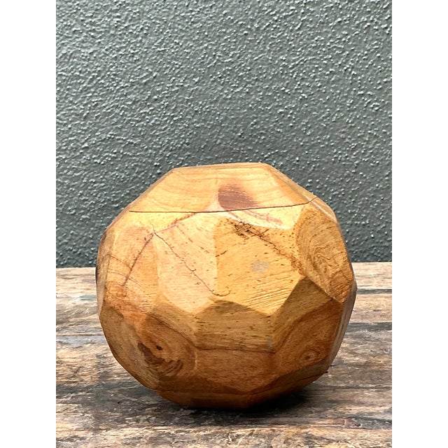 Embrace the soulful intersection of geometry and nature with this striking vintage faceted wood sphere. A masterclass in...