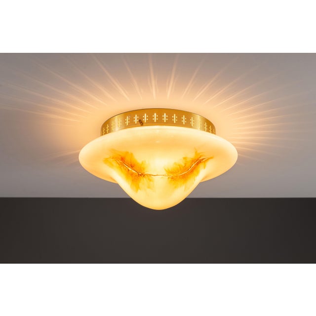 This vintage ceiling lamp by Rosdala Glasbruk is a striking example of Scandinavian design, where craftsmanship and...