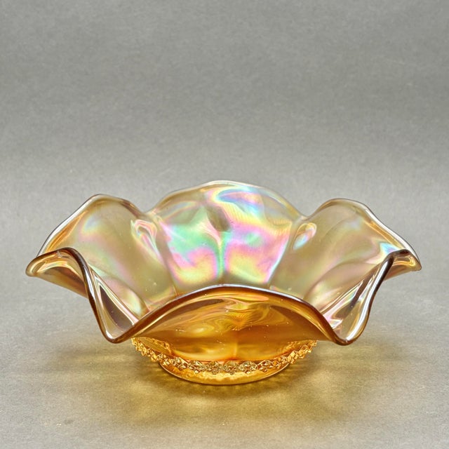 This stunning antique marigold carnival glass bowl, produced by Imperial Glass in the 1920s, features the classic Optic...