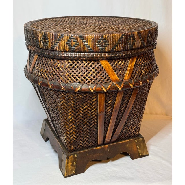 Vintage Chinese woven bamboo, rattan and wood storage basket or low side table with brass accents at the feet. Excellent...