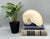 Striking oversized nautilus shell with beautiful natural iridescence and a sculptural spiral form. The shell displays soft...