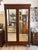 This Antique French Empire Mahogany Mirrored Armoire is a stunning piece of furniture that exudes elegance and...