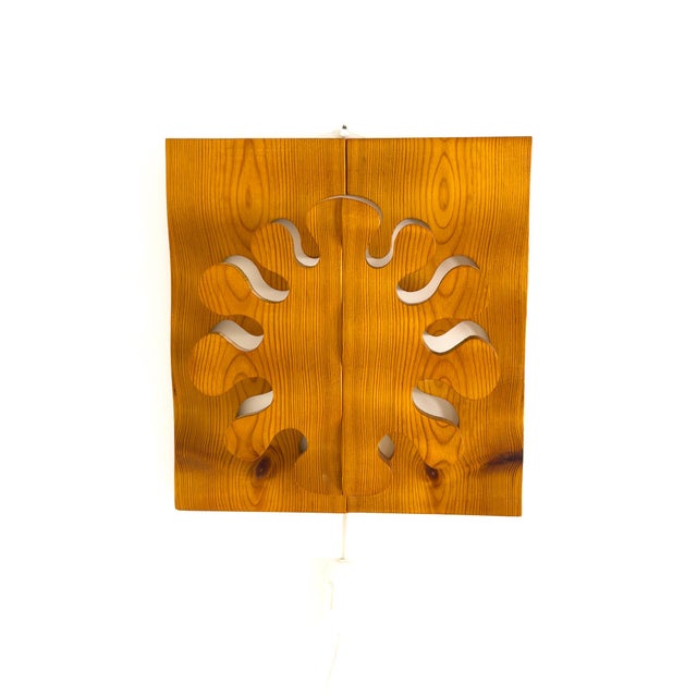 A sculptural wall light designed and crafted by Gunnar Kanevad, Sweden, circa 1980. Executed in solid pine, the piece...
