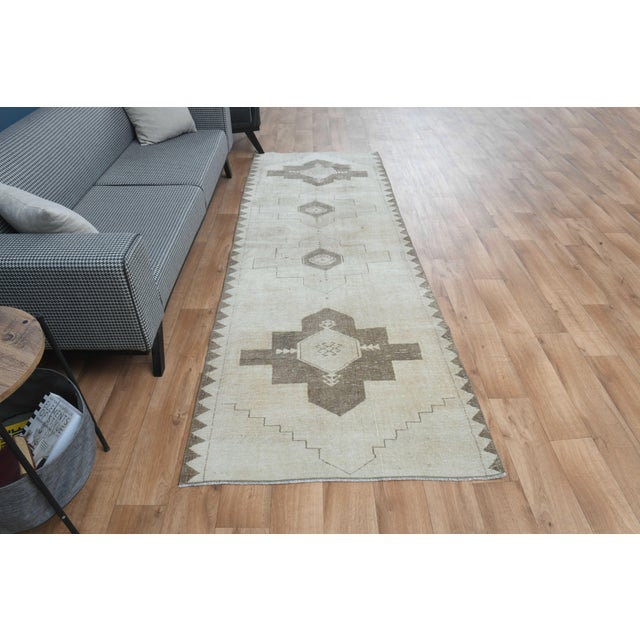 This vintage hand-knotted area rug is a semi-antique vintage area rug. The '70s Eastern region of Anatolian's unique rug...