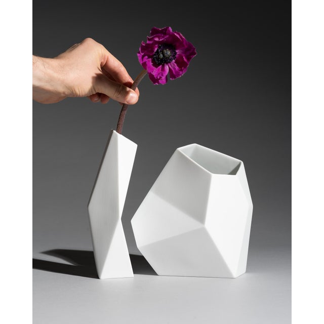 A complementary pair of matte white bisque porcelain vases from the Surface collection, designed by Achim Haigis for...
