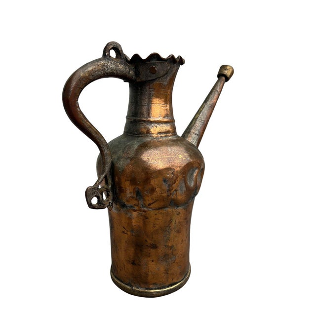 This striking antique copper vessel features a sculptural, figural body with a beautifully aged patina developed over...