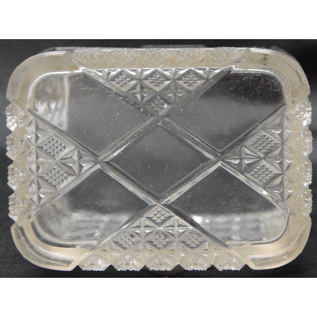 This is a stunning antique lidded pressed glass casket. The box is composed of pressed glass with panels decorated with a...