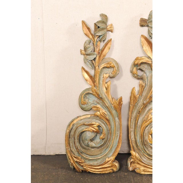 An Italian pair of carved and gilt wood architectural fragments from the early 19th century. This antique pair of...