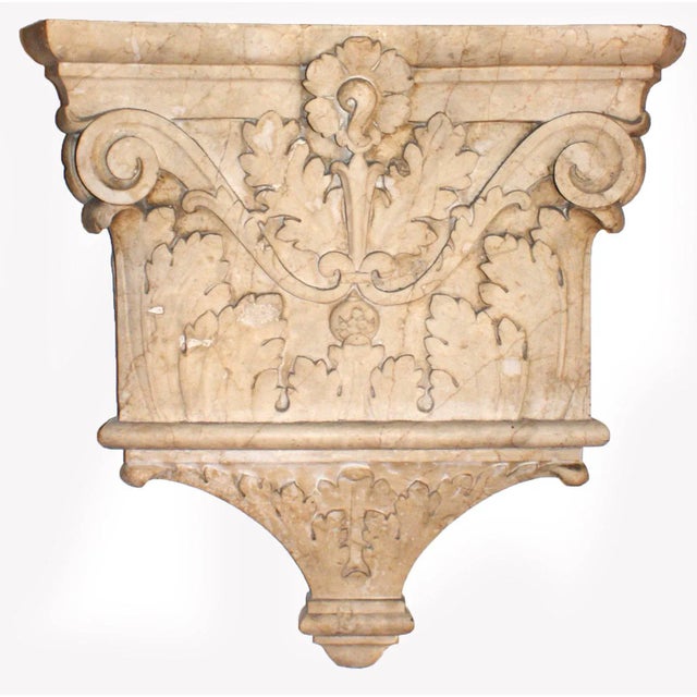 Antique early 20th century pair of ornately carved marble column capitals having foliate decoration, volute scrolls,...
