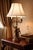 Substantial vintage figural table lamp featuring two classical cherubs supporting a three-arm candle-style light. Executed...
