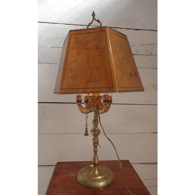 This Bouillotte-type table lamp was made in the United States in the early 1900s in French style. It has a brass base with...