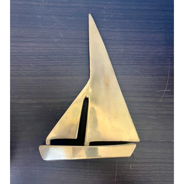 This vintage Brass Sailboat is a lovely example of MCM sculpture it has simple clean lines and the sail is rotatable....
