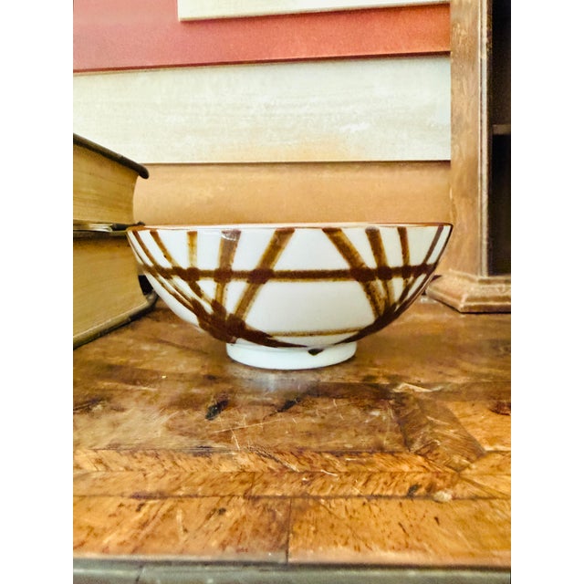 Vintage porcelain bowl by OMC Japan featuring a bold, hand-painted brown brushstroke design over a creamy white ground....