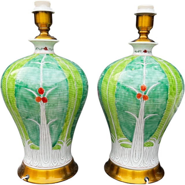 Pair of hand-painted porcelain lamps features a beautifully proportioned bulbous melon shape, showcasing the traditional...