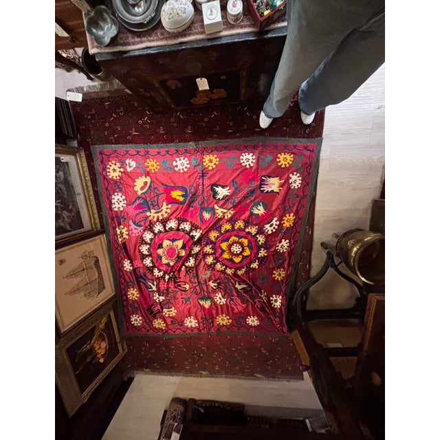 A striking vintage Uzbek suzani textile dating to approximately the 1960s–1970s, featuring richly colored silk embroidery...