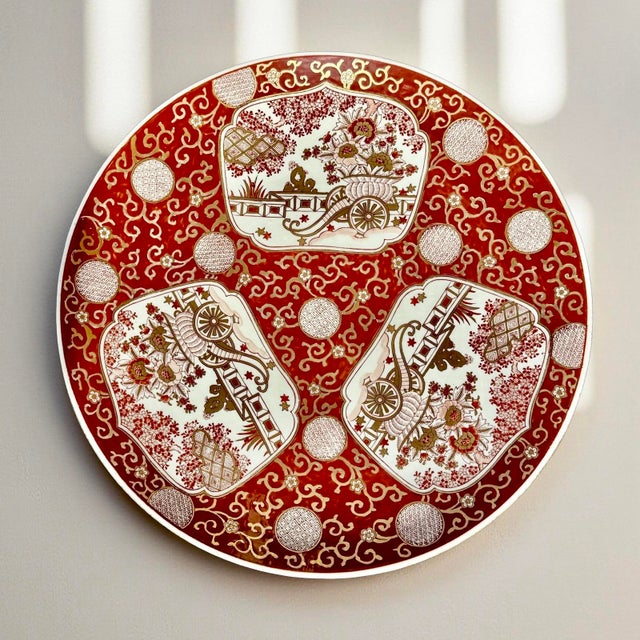 This very large antique Japanese Imari porcelain charger plate dates to the early 20th century and is hand-painted in the...