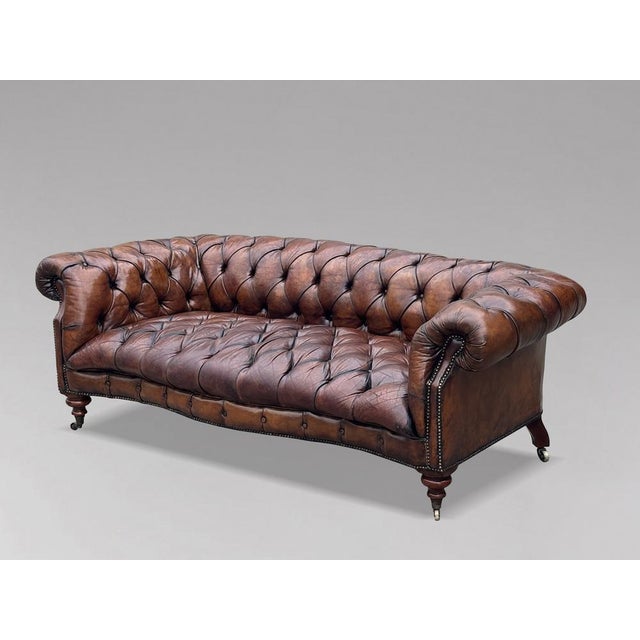Stunning 19th-Century Victorian Brown Leather Serpentine Chesterfield Sofa This exceptional and rare 19th-century...