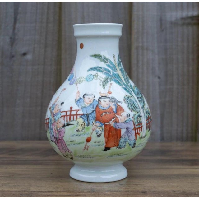 A beautifully proportioned Chinese famille rose porcelain vase, distinguished by its rounded bulbous form, colourful...