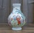 A beautifully proportioned Chinese famille rose porcelain vase, distinguished by its rounded bulbous form, colourful...