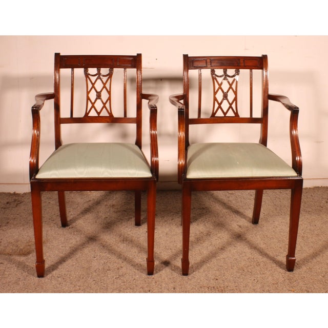 Superb pair of Hepplewhite Revival armchairs in English mahogany. A very beautiful pair of solid mahogany armchairs from...