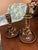 Striking pair of vintage brass candlesticks featuring a twisted column wrapped with a stylized serpent motif. The...