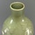 This antique Chinese Longquan celadon gourd vase is decorated with raised floral relief carving over the body. The elegant...