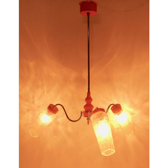 Three-branch pendant centre light on stem, in the style of Kaiser. The branches have lens shades that create a dappled...