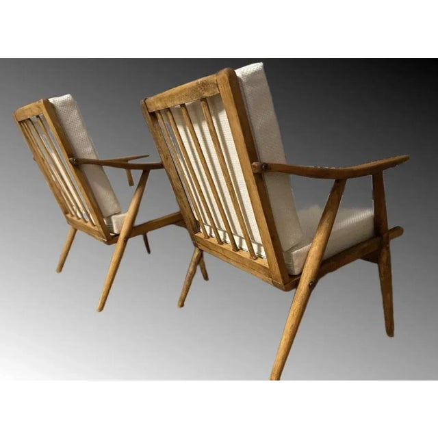 These chairs have been refurbished with brand new cushions as well as brand new upholstery. This pair of 1960s wooden...