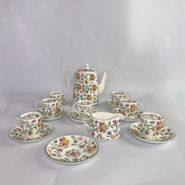 A timeless and highly collectible vintage English bone china tea set in the iconic Haddon Hall pattern by Minton. This...