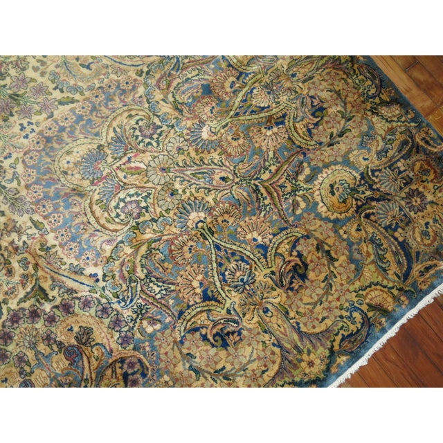 An incredible palace size earlier 20th century Kermanshah rug in predominant blues, gray and raspberry. Woven with the...