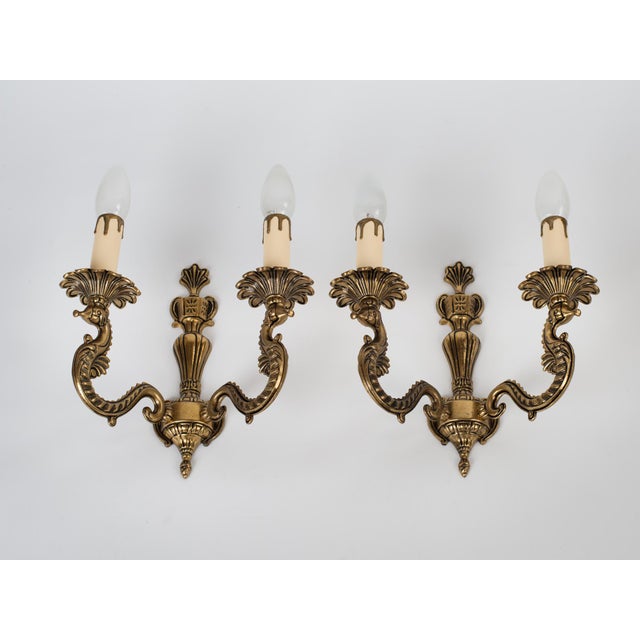 Spectacular 1950s Spanish French Neoclassical Style Cast Brass 2-Light Wall Sconces with zoomorphic details. Masterfully...
