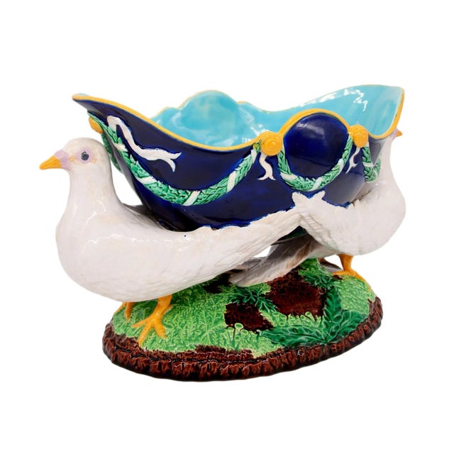 A George Jones Majolica Centerpiece, the cobalt glazed shaped bowl supported by two naturalistically molded and glazed...