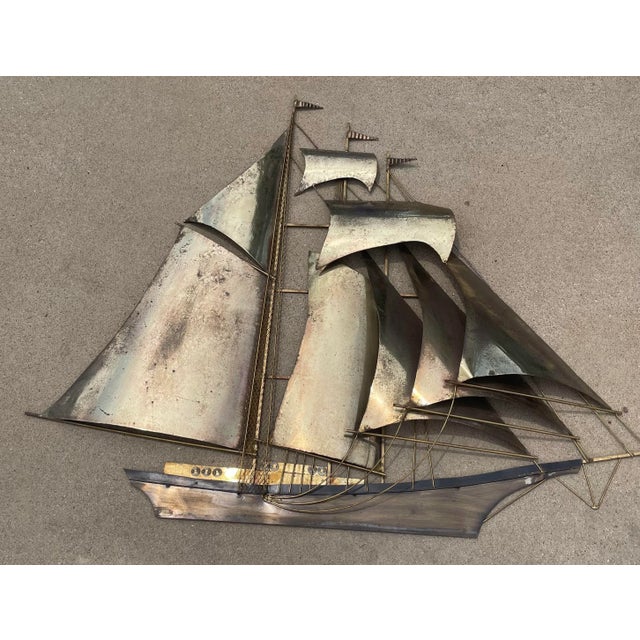 Love this monumental metal ship form wall art. Signed by Wiley.