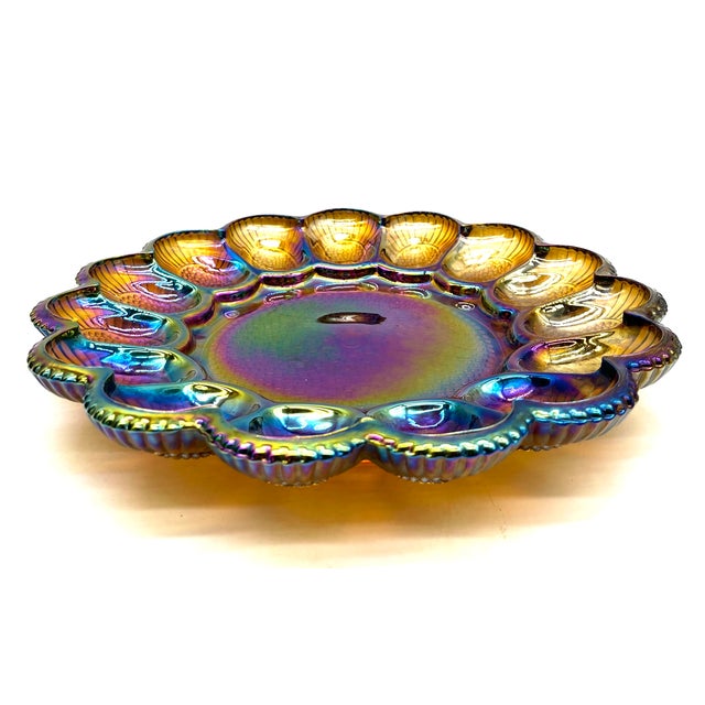 An exquisite, unused egg dish/relish dish made of iridescent gold carnival glass, manufactured by the Indiana Glass...