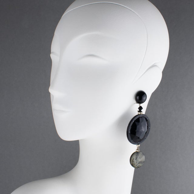 Angela Caputi designed these sophisticated made-in-Italy dangle clip-on earrings. The pieces boast a black contrast with a...