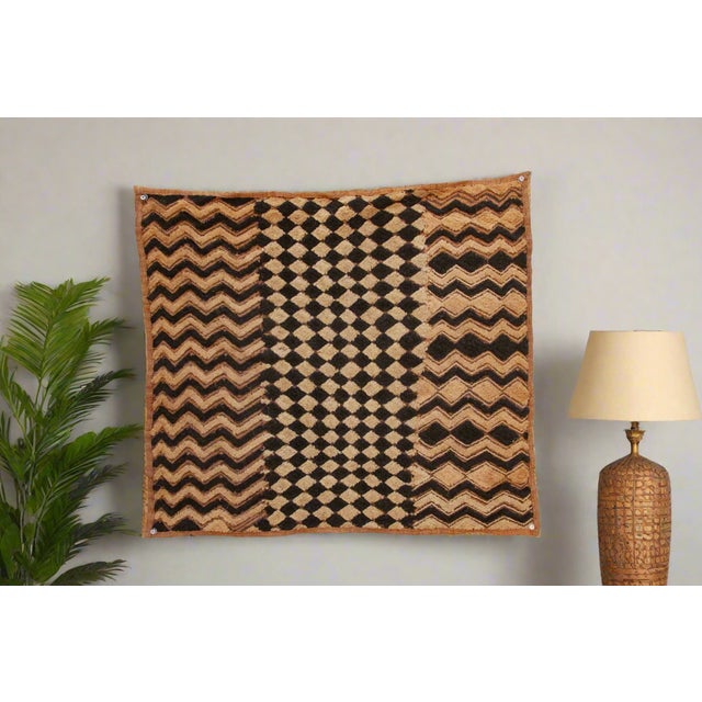 A captivating masterpiece of African textile art, this vintage Kuba cloth panel is a testament to the unparalleled...