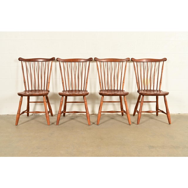 A gorgeous set of four American Colonial or Arts & Crafts style solid cherry wood spindle back Windsor dining chairs By L....