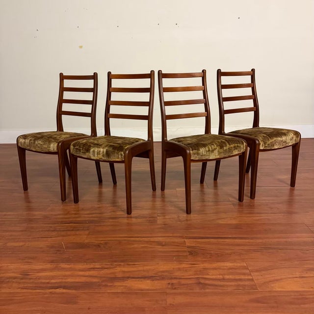 Set of four vintage ladderback dining chairs made in the U.K. by G-Plan circa early 1970's. Featuring afromosia (African...