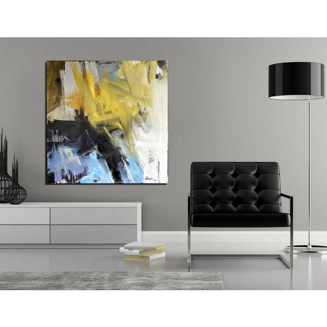 Bold, sweeping brushstrokes in yellow, black, blue, and white intersect and overlap, creating a dynamic abstract...