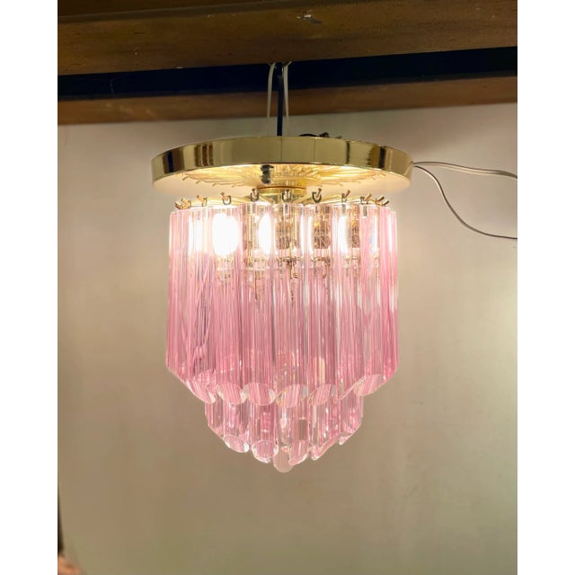 Pop and classic flush-mounted pendant light made of 44 pink striated full-tubes Murano glass suspended on a golden...