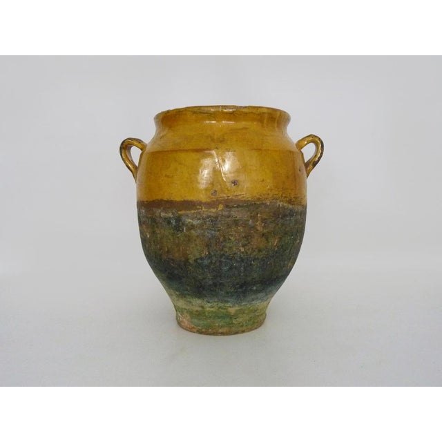 Antique yellow glazed terracotta pot. It will look beautiful in your kitchen as a utensil holder. You can also place it in...