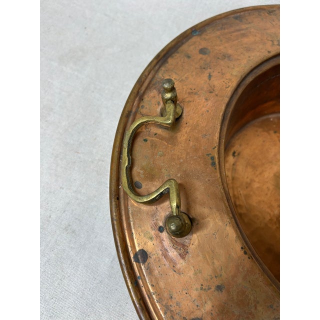 Large vintage handmade copper bowl. The bowl has detailed handles, a deep bowl and wide brim. There is a beautiful...