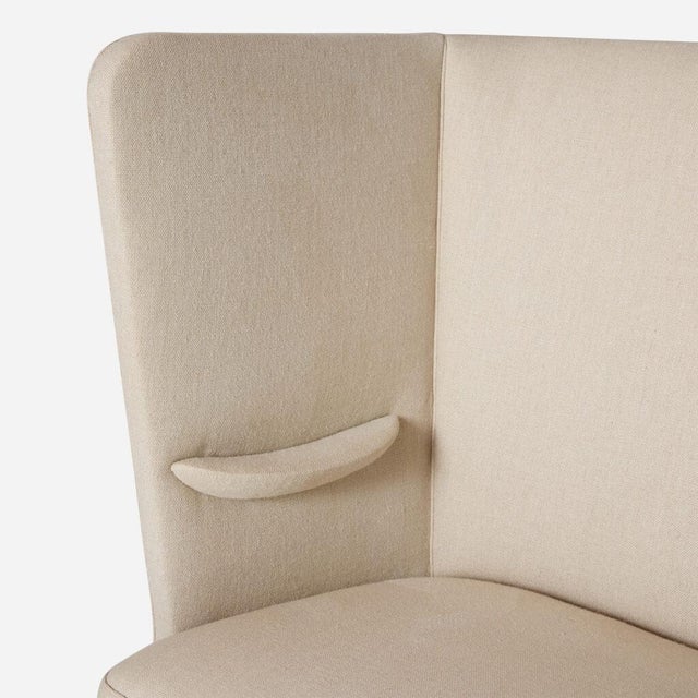 Frits Henningsen Settee Denmark, c1940s A high-backed settee designed by Frits Henningsen, featuring linen fabric...